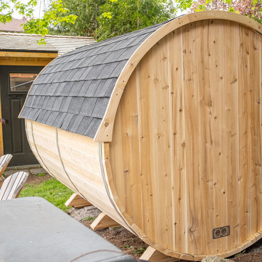 Black asphalt shingle roof with trim for a barrel sauna