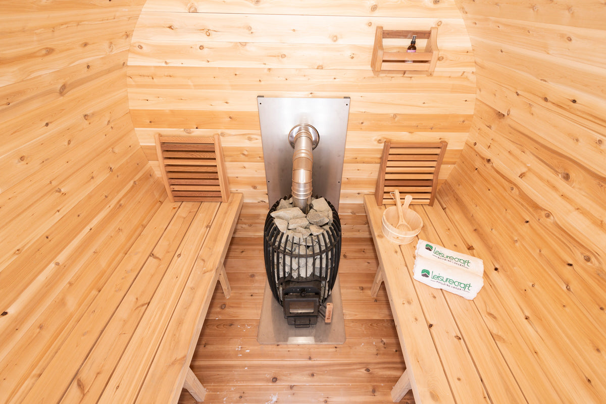 CT Elation sauna interior with facing cedar benches and the wood-burning heater