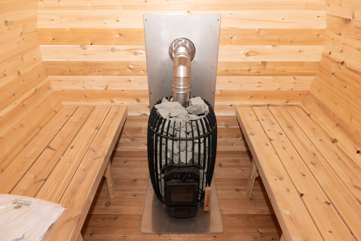 CT Elation sauna heater loaded with stones behind its cedar guard rail