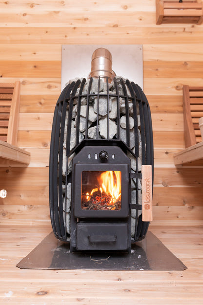 CT Elation sauna wood stove with a fire burning behind the stone-topped guard