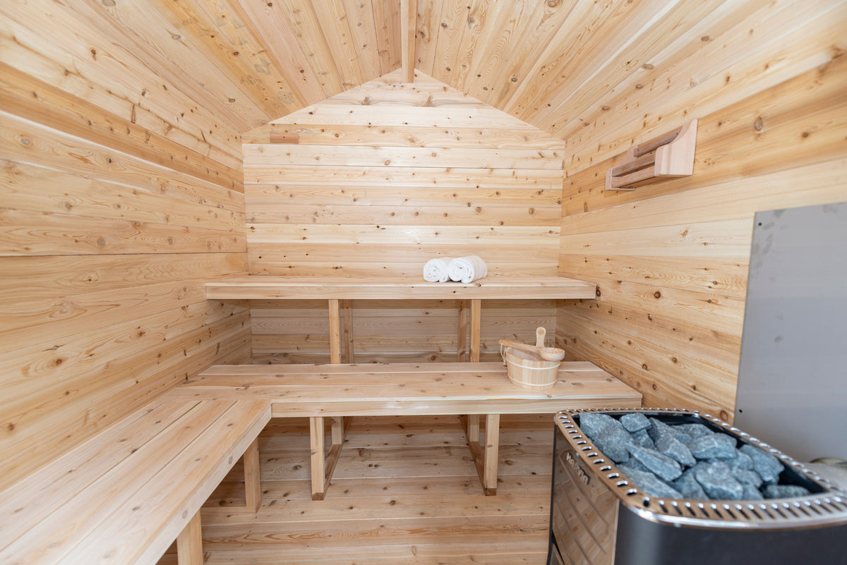 CT Georgian sauna interior with L-shaped cedar benches and the electric heater
