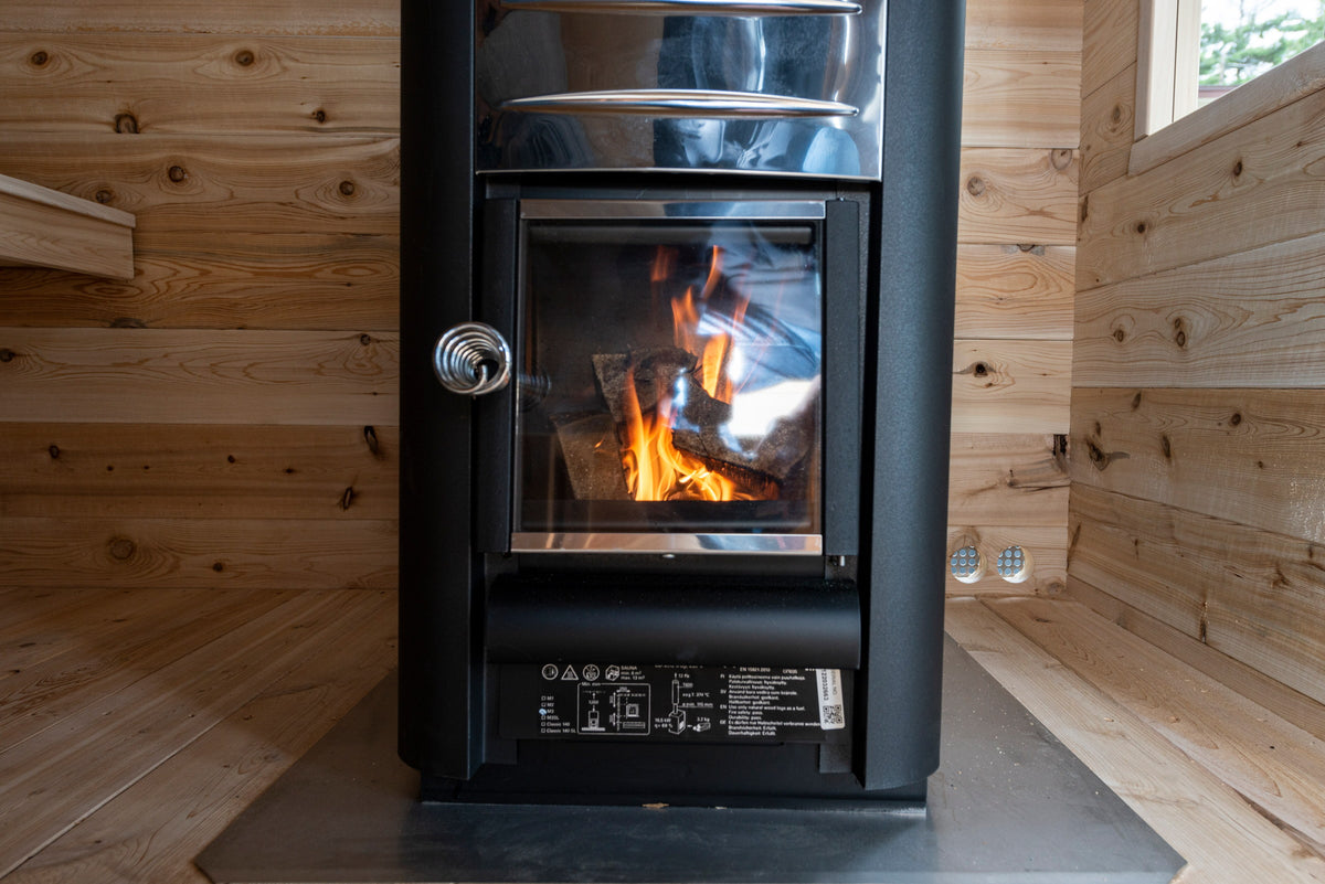 Wood-burning stove lit inside the CT Georgian cabin sauna