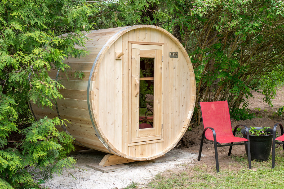 CT Harmony barrel sauna three-quarter view showing the full cedar barrel body, staved roof and window door