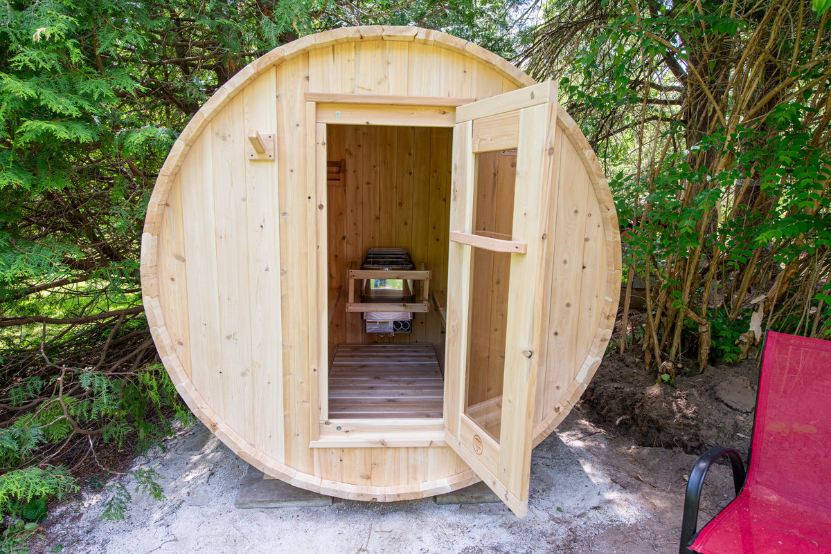 CT Harmony barrel sauna with the door open showing the cedar interior benches and slatted floor