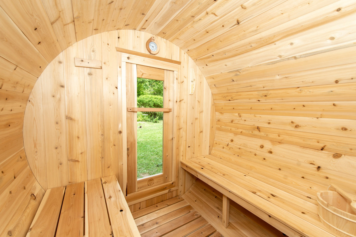 CT Harmony barrel sauna interior looking back toward the window door and wall-mounted thermometer