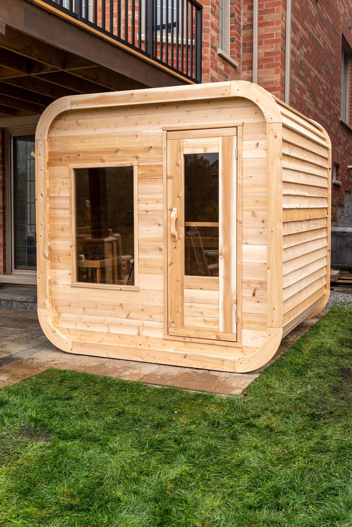 CT Luna sauna exterior three-quarter view in Eastern White Cedar with bronze tempered glass door