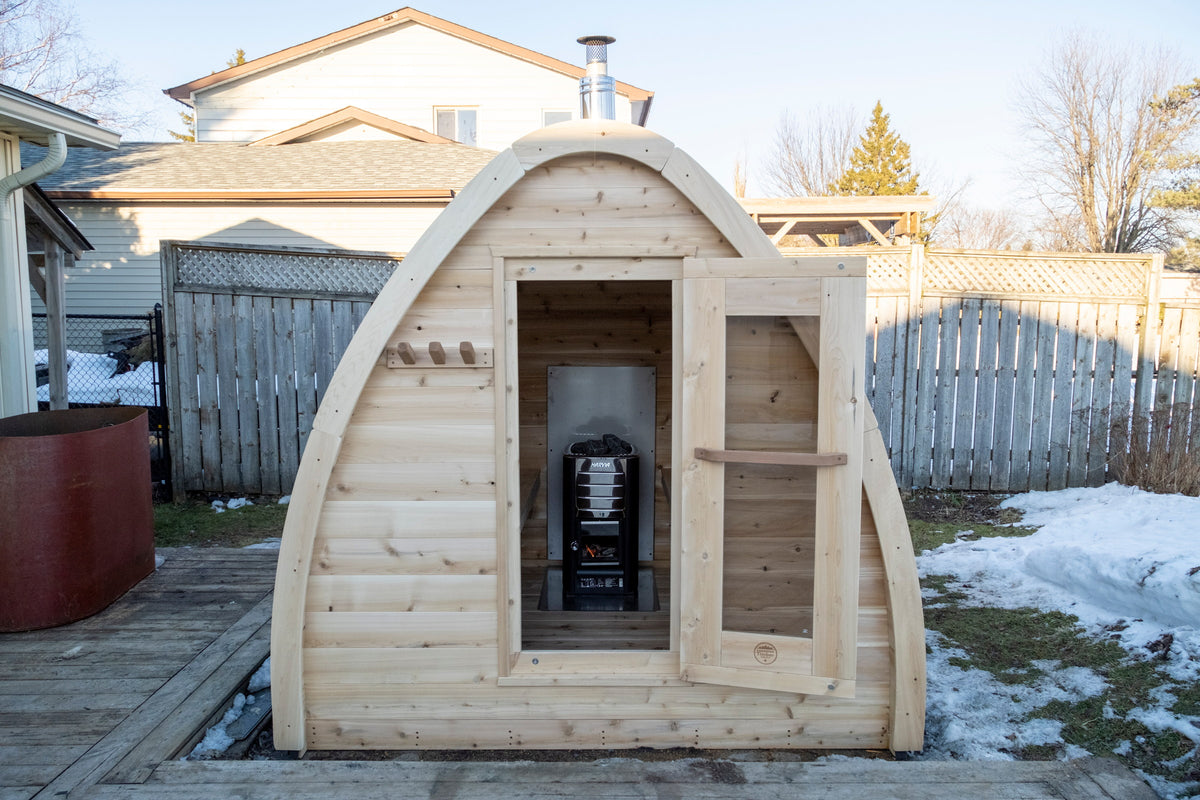 CT MiniPOD sauna with the door open showing the stove and cedar interior