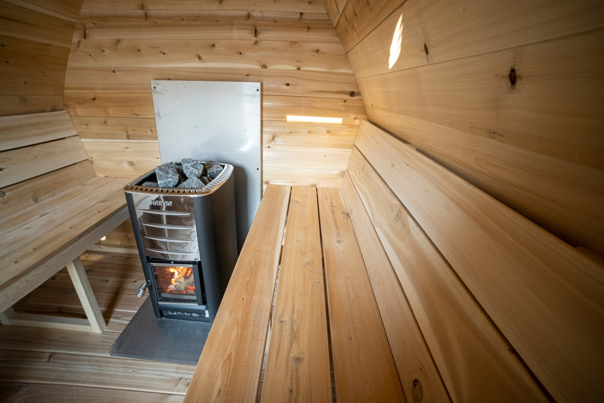 CT MiniPOD sauna stove and bench return seen from the far end of the pod