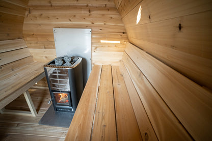 CT MiniPOD sauna stove and bench return seen from the far end of the pod