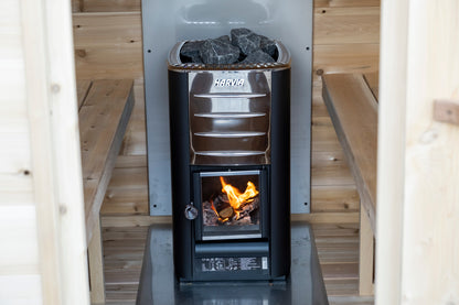 Wood stove burning inside the CT MiniPOD sauna with stones on the tray