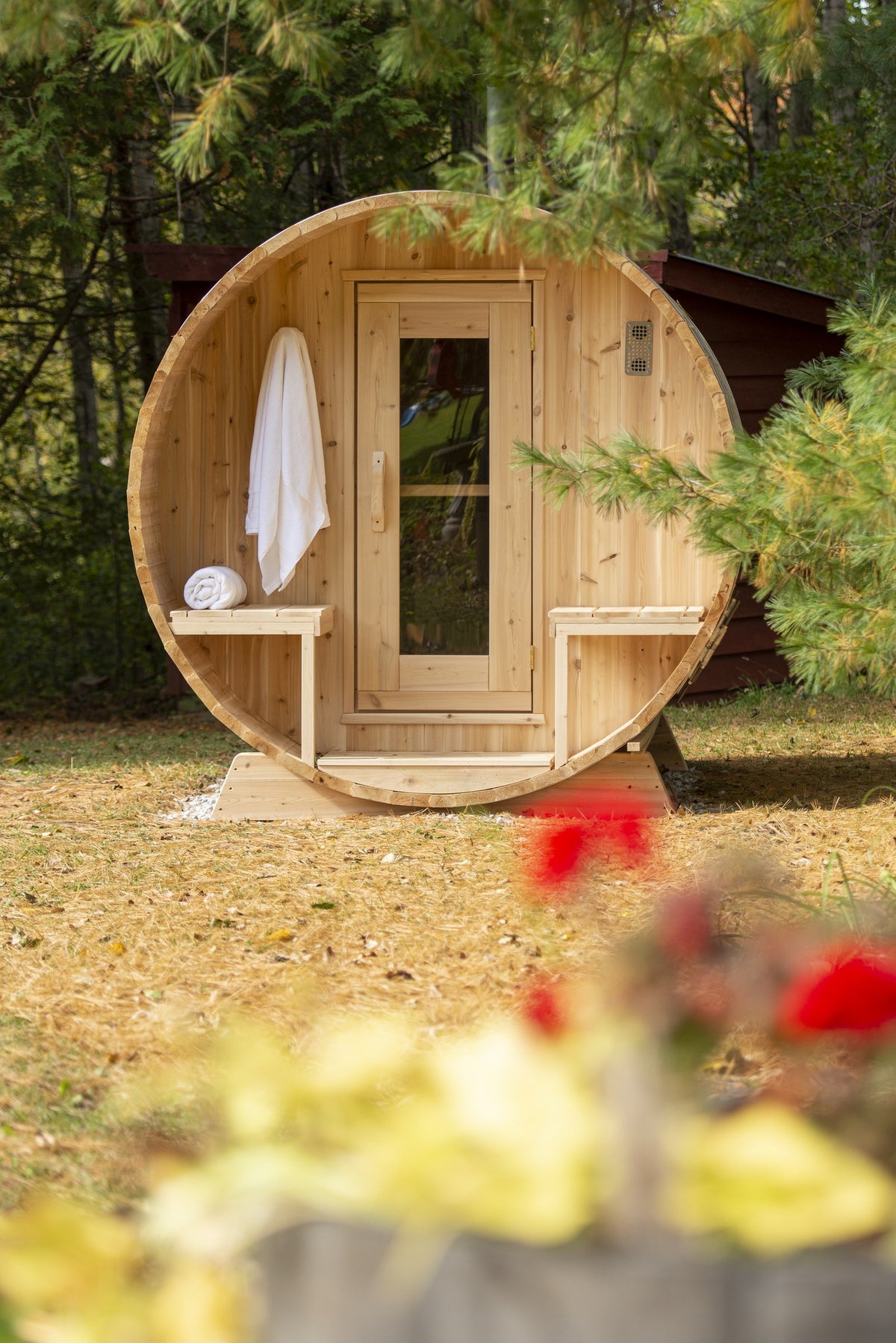 CT Serenity outdoor sauna porch styled with towels in a wooded backyard setting