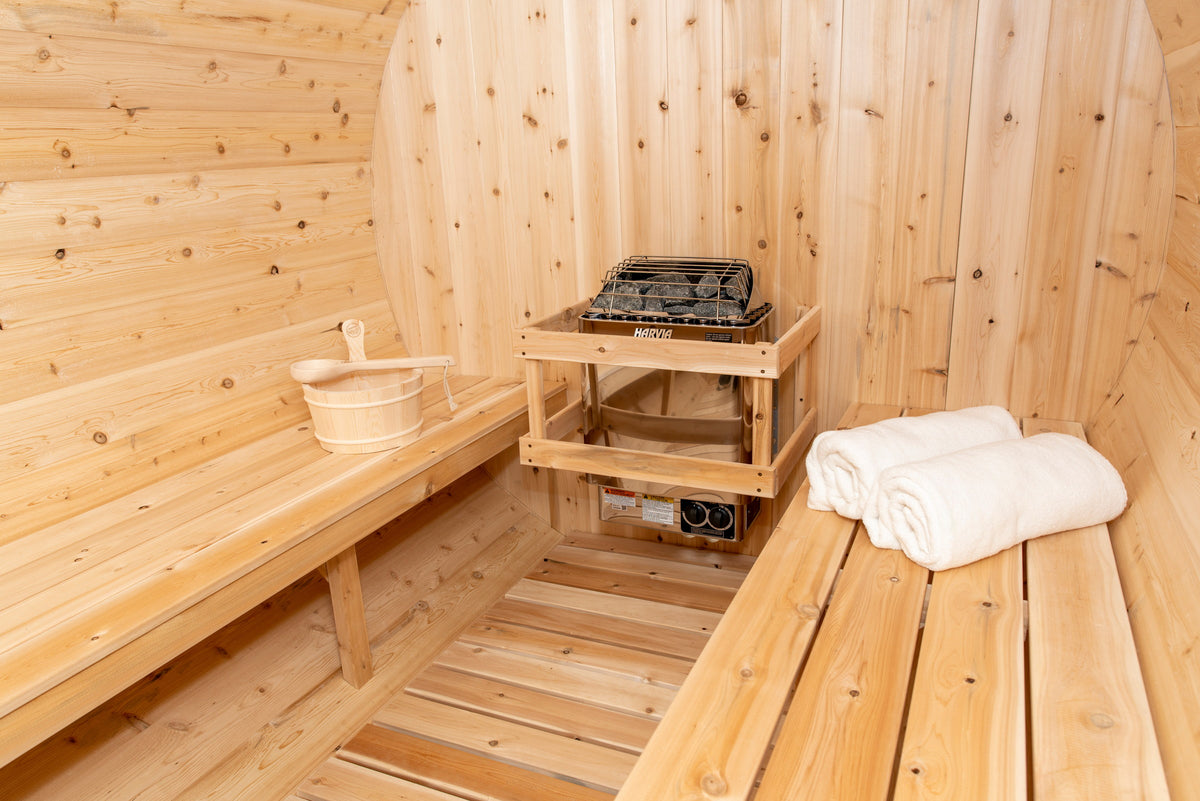 CT Tranquility sauna interior with the heater, cedar bucket and rolled towels