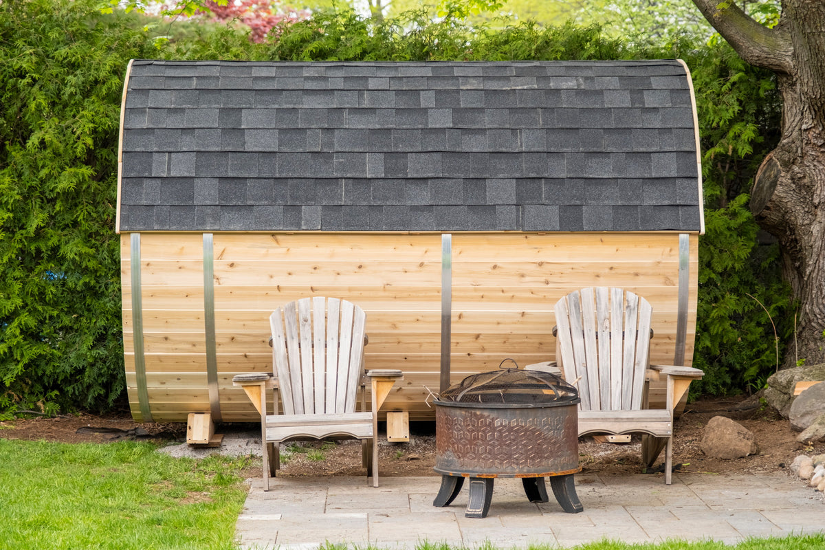 CT Tranquility barrel sauna fitted with the optional black asphalt shingle roof, in a backyard